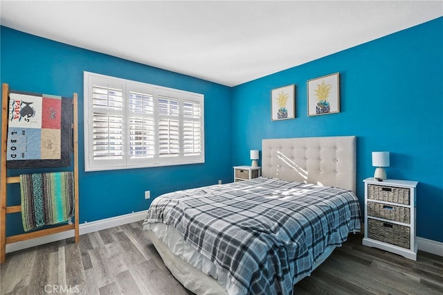 bedroom featuring wood finished floors and baseboards