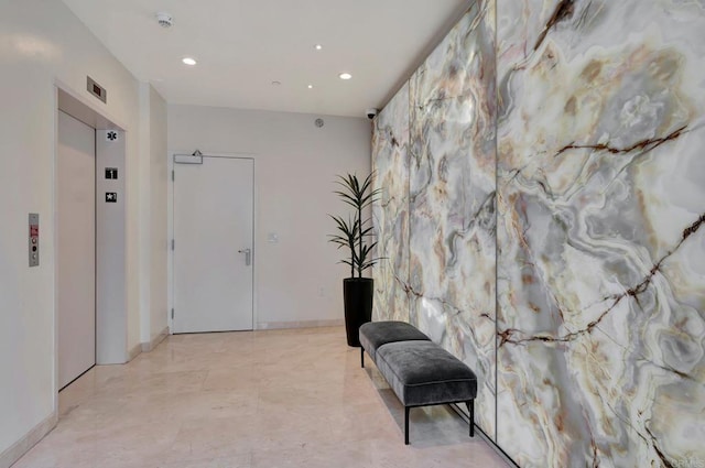 living area featuring baseboards, recessed lighting, and elevator