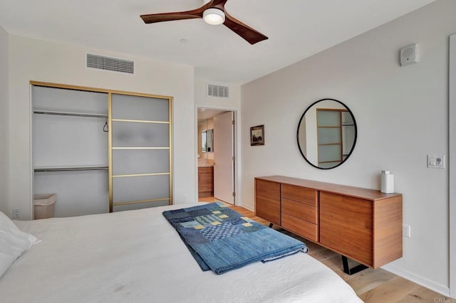 bedroom featuring light wood-style flooring, visible vents, ceiling fan, and a closet