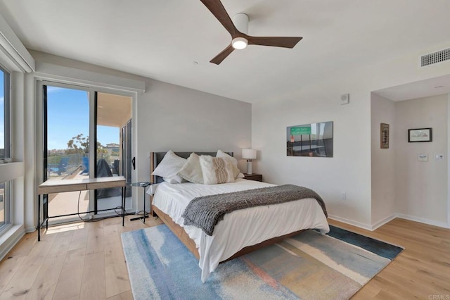 bedroom with visible vents, ceiling fan, light wood-style flooring, and baseboards