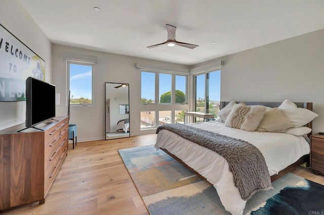 bedroom with light wood finished floors, access to outside, and baseboards