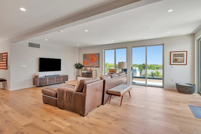 living room with recessed lighting, light wood-type flooring, and visible vents