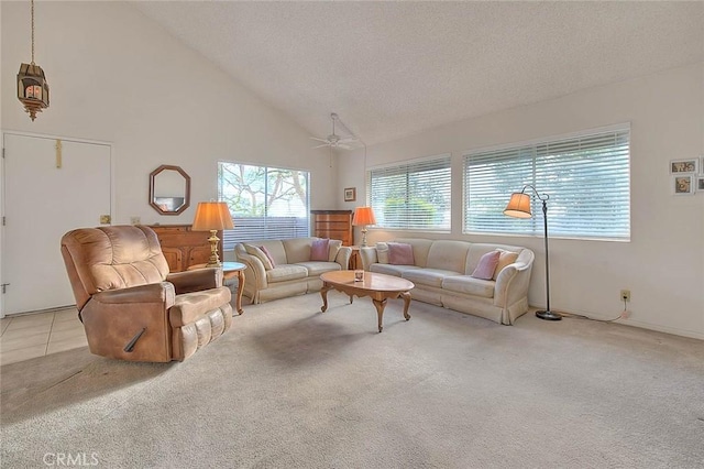 living room featuring high vaulted ceiling, light colored carpet, a ceiling fan, and a textured ceiling