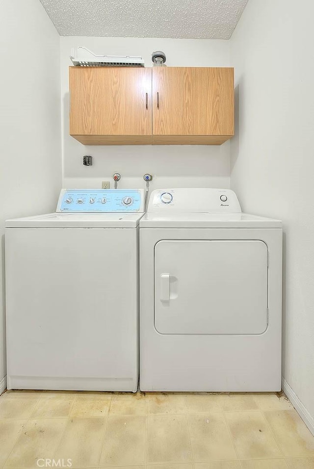 laundry area featuring cabinet space and washing machine and clothes dryer
