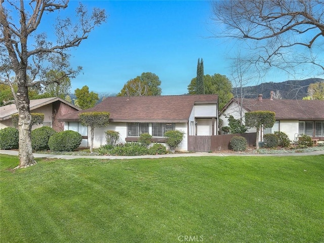 single story home featuring fence and a front yard