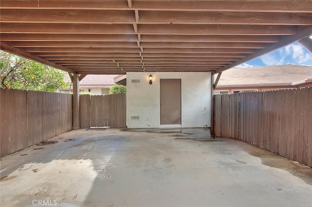 view of patio / terrace featuring a fenced backyard and a carport