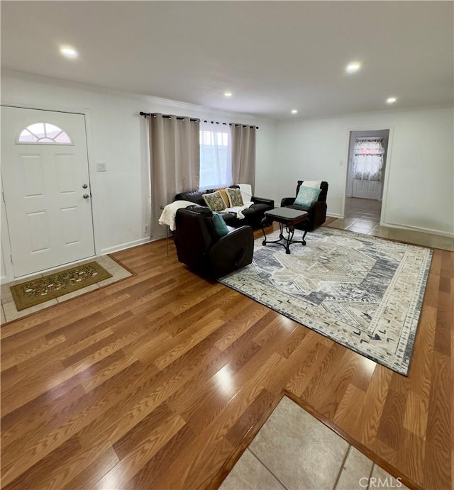 living room with recessed lighting, baseboards, and wood finished floors