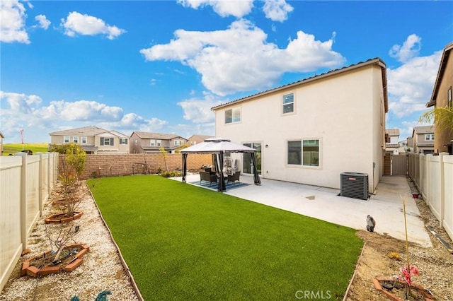 back of property featuring a patio, central AC unit, a fenced backyard, a yard, and a gazebo