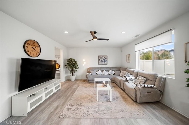 living area featuring a ceiling fan, wood finished floors, visible vents, and recessed lighting