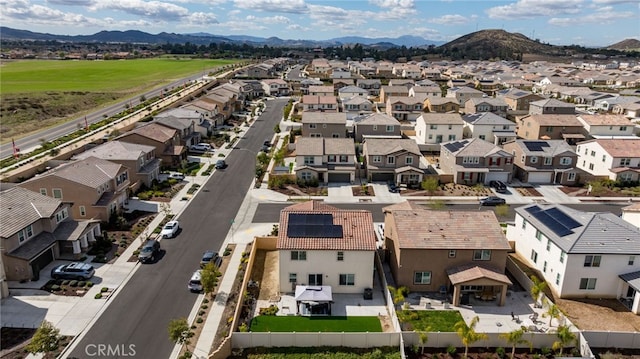 drone / aerial view featuring a residential view and a mountain view