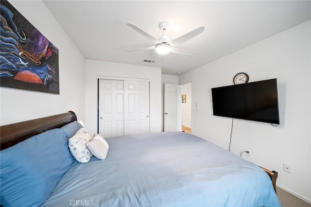 bedroom featuring carpet, a closet, visible vents, and ceiling fan