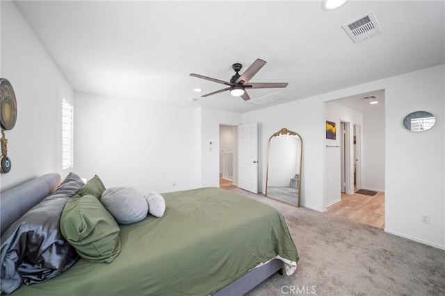 carpeted bedroom featuring ceiling fan, visible vents, baseboards, and recessed lighting