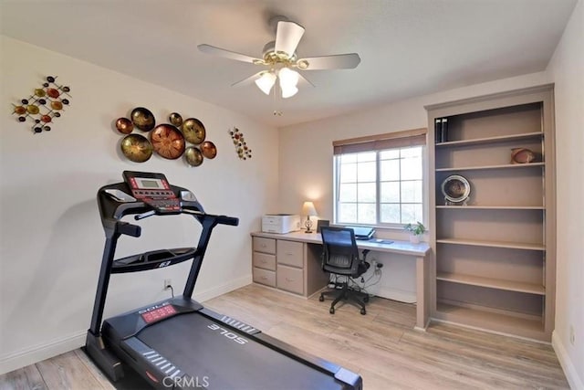 exercise room featuring ceiling fan, baseboards, and light wood-style flooring