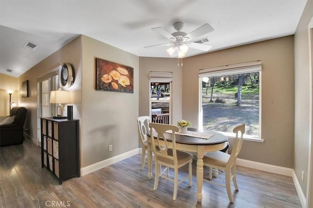 dining area with wood finished floors, visible vents, and baseboards
