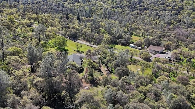 birds eye view of property featuring a view of trees