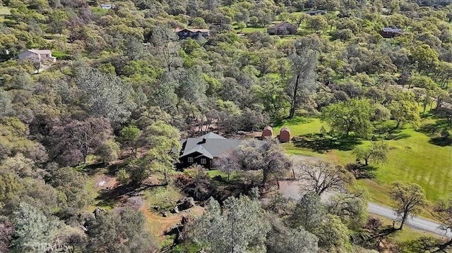 birds eye view of property with a view of trees