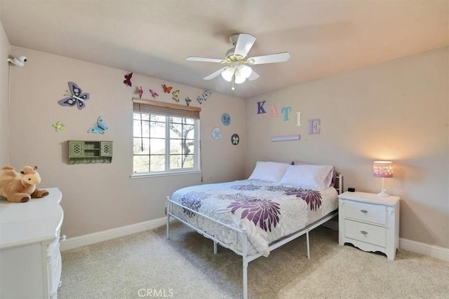 bedroom featuring baseboards, light carpet, and ceiling fan