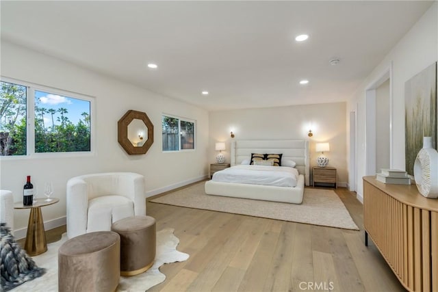 bedroom with light wood finished floors, baseboards, and recessed lighting