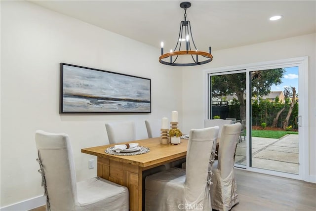 dining space featuring an inviting chandelier, wood finished floors, and recessed lighting