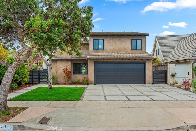 view of front of house with concrete driveway, an attached garage, fence, and stucco siding