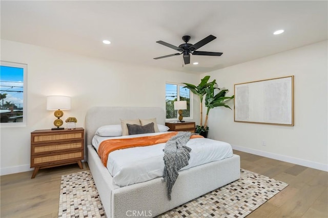 bedroom with a ceiling fan, recessed lighting, baseboards, and wood finished floors