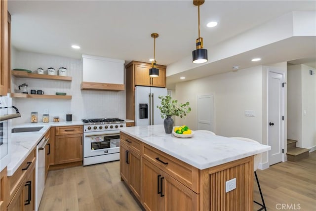 kitchen with a sink, high quality appliances, light wood-type flooring, open shelves, and custom range hood