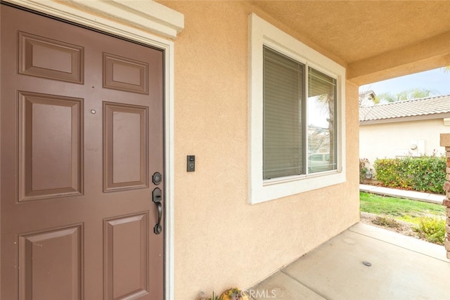 doorway to property with stucco siding