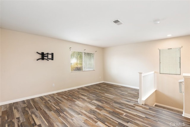 spare room featuring recessed lighting, visible vents, wood finished floors, and baseboards