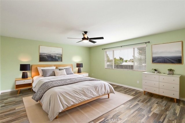 bedroom with wood finished floors, a ceiling fan, and baseboards