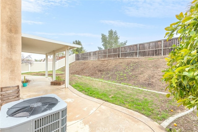 view of yard with a patio, central AC unit, and a fenced backyard