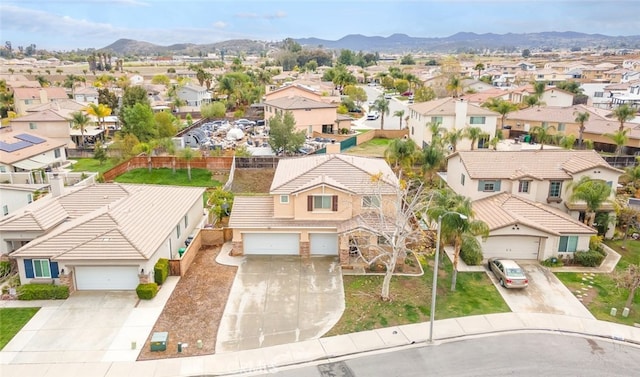 birds eye view of property with a mountain view and a residential view