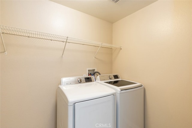 clothes washing area with laundry area and washer and clothes dryer