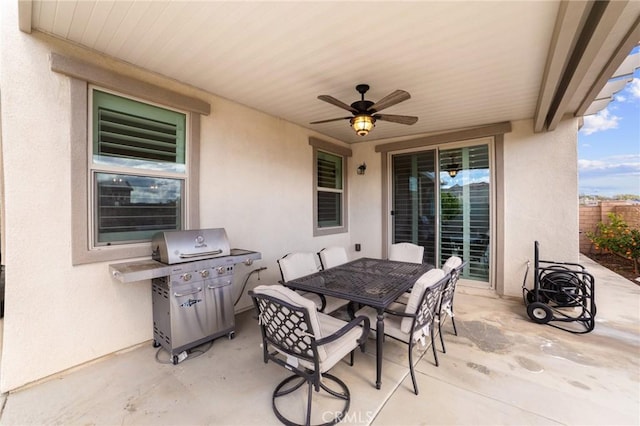 view of patio / terrace with ceiling fan, fence, a grill, and outdoor dining area