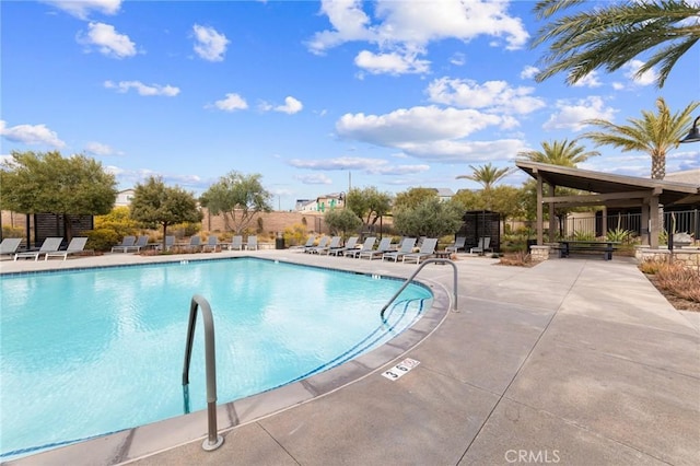 pool featuring a patio area and fence