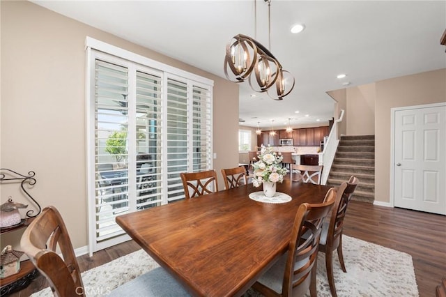 dining space featuring dark wood-style floors, recessed lighting, stairway, a chandelier, and baseboards