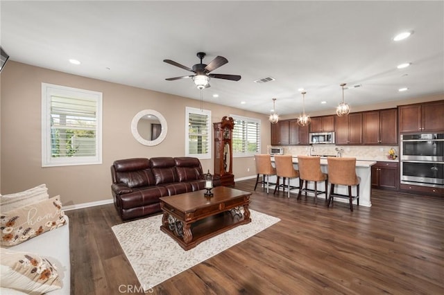 living area with recessed lighting, a ceiling fan, visible vents, baseboards, and dark wood-style floors