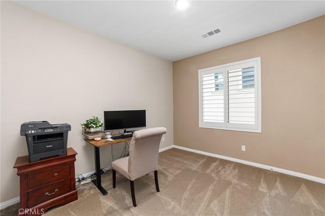 office area with carpet floors, baseboards, and visible vents