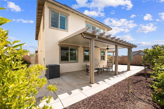 rear view of house with a ceiling fan, a patio, fence, cooling unit, and stucco siding