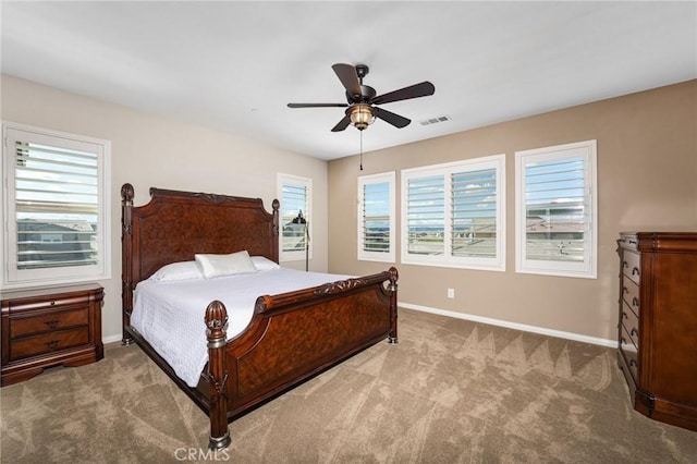 carpeted bedroom featuring baseboards, visible vents, and ceiling fan