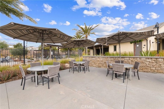 view of patio with fence and outdoor dining space