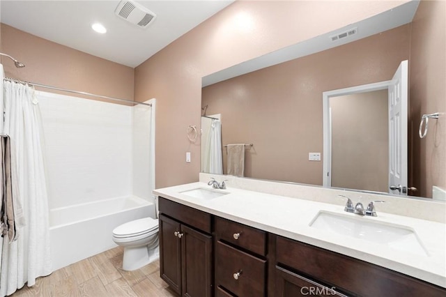 full bathroom featuring visible vents, a sink, and toilet