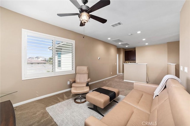 living room with recessed lighting, light carpet, a ceiling fan, visible vents, and baseboards