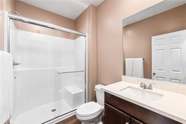 full bath featuring a shower stall, toilet, and vanity