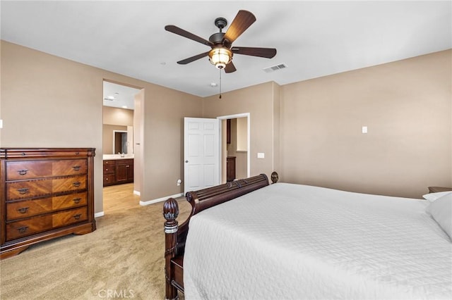 bedroom featuring visible vents, light carpet, ceiling fan, ensuite bath, and baseboards