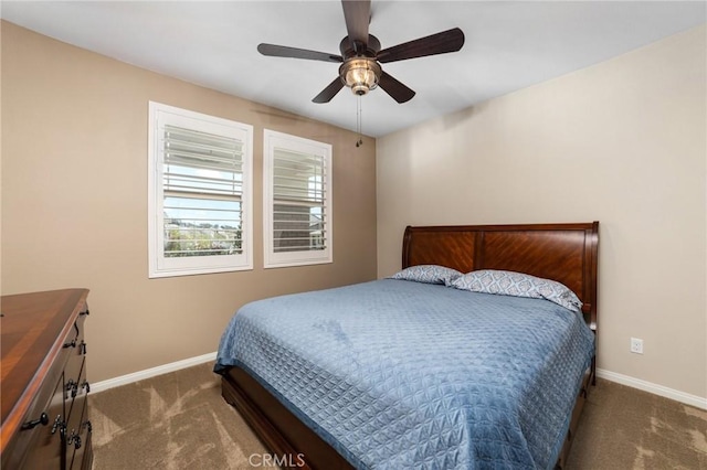 bedroom with a ceiling fan, baseboards, and carpet flooring