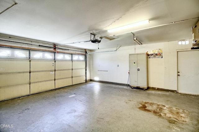 garage featuring baseboards and a garage door opener