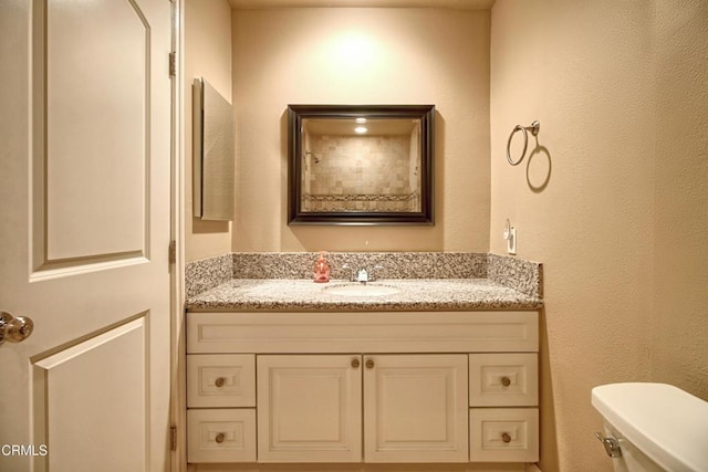 bathroom with toilet and vanity