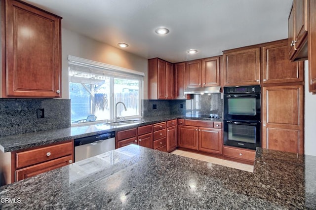 kitchen featuring dobule oven black, decorative backsplash, stainless steel dishwasher, a sink, and under cabinet range hood