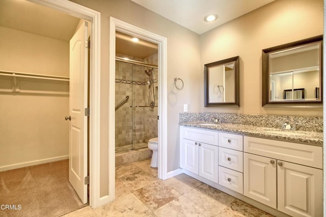 full bath with a stall shower, a sink, and double vanity