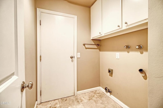 washroom featuring cabinet space, electric dryer hookup, and baseboards